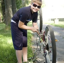 Boy repairing bicycle 